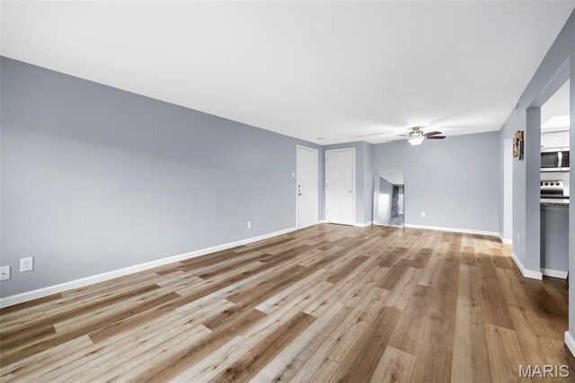 11 Fairways Cir Unit A, Saint Charles, MO 63303 - unfurnished living room featuring a ceiling fan, wood finished floors, and baseboards