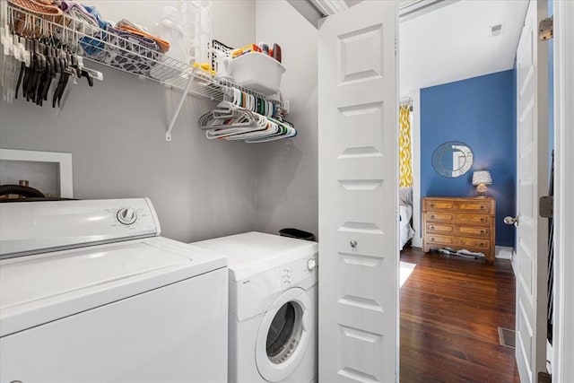 washroom with washing machine and clothes dryer and dark wood-style floors
