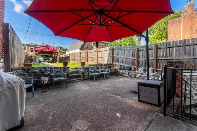 view of patio / terrace featuring a gazebo, outdoor dining space, and a fenced backyard
