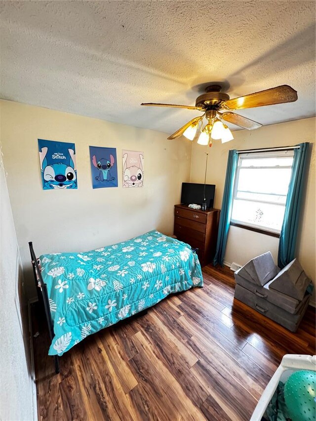 308 N Ellen St, Dixon, MO 65459 - bedroom featuring a textured ceiling, wood finished floors, and ceiling fan