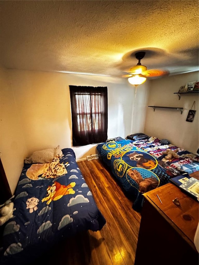 308 N Ellen St, Dixon, MO 65459 - bedroom with wood finished floors, a textured ceiling, and ceiling fan