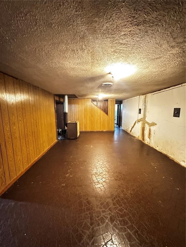308 N Ellen St, Dixon, MO 65459 - finished below grade area featuring wood walls, dark floors, and a textured ceiling