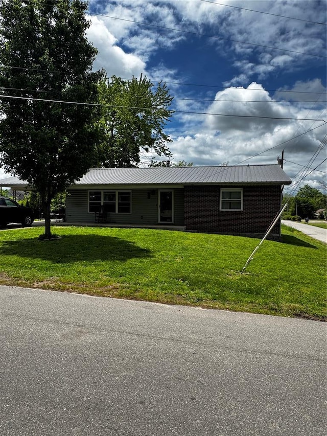 308 N Ellen St, Dixon, MO 65459 - ranch-style home featuring a front yard, metal roof, and brick siding