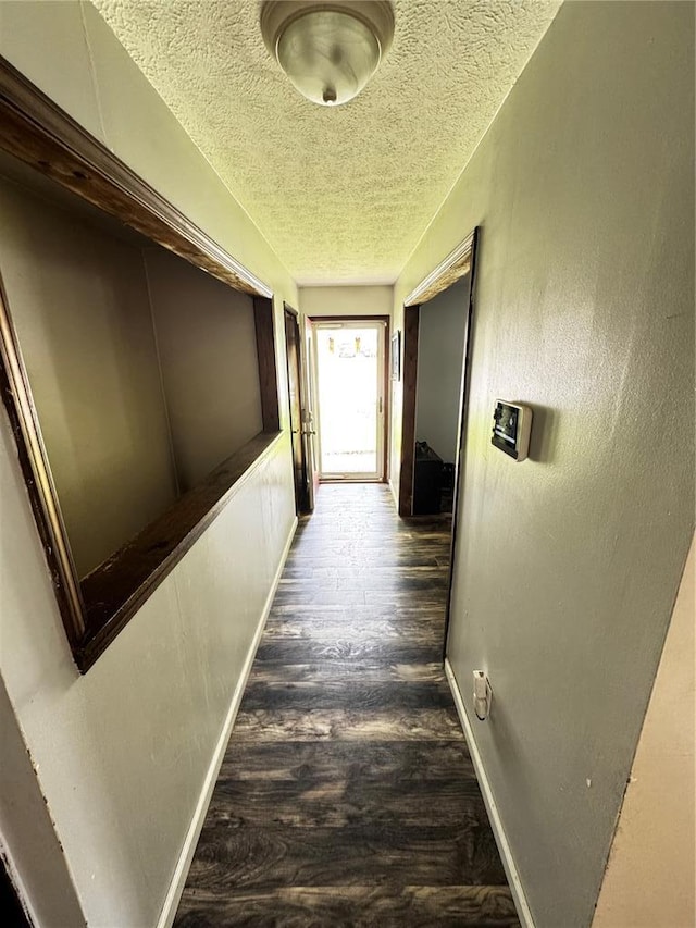 308 N Ellen St, Dixon, MO 65459 - corridor with a textured ceiling, baseboards, and dark wood-style flooring