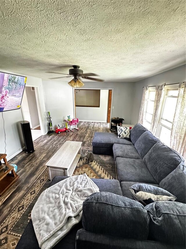 308 N Ellen St, Dixon, MO 65459 - living area with wood finished floors, a ceiling fan, and a textured ceiling