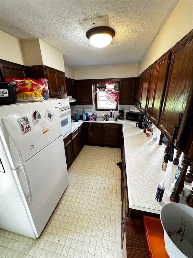 308 N Ellen St, Dixon, MO 65459 - kitchen with white appliances, light countertops, a textured ceiling, dark brown cabinets, and a sink