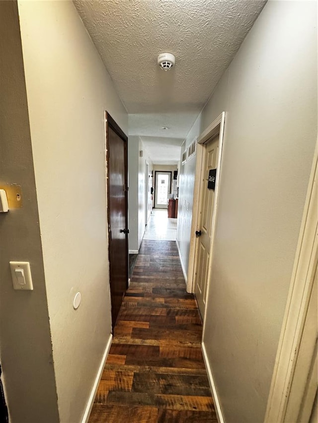 308 N Ellen St, Dixon, MO 65459 - hall with wood finished floors, baseboards, and a textured ceiling