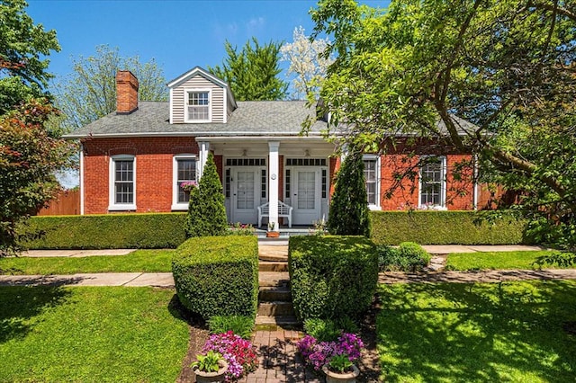 100 W Alton St, Marine, IL 62061 - new england style home with a chimney, brick siding, and a porch