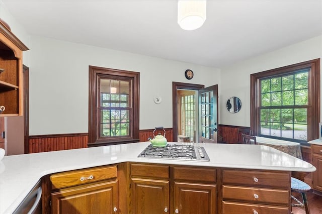 100 W Alton St, Marine, IL 62061 - kitchen with stainless steel appliances, wainscoting, light countertops, open shelves, and wood walls