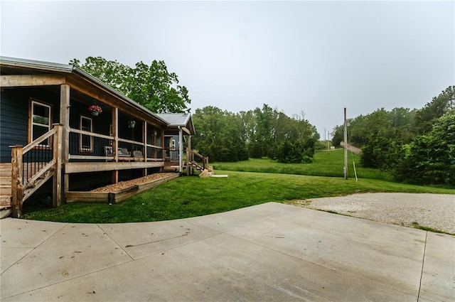 view of grassy yard featuring a porch