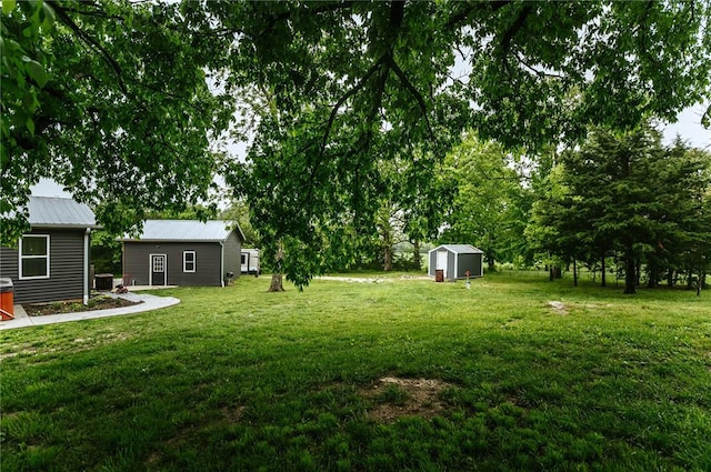 view of grassy yard featuring an outdoor structure and a storage shed