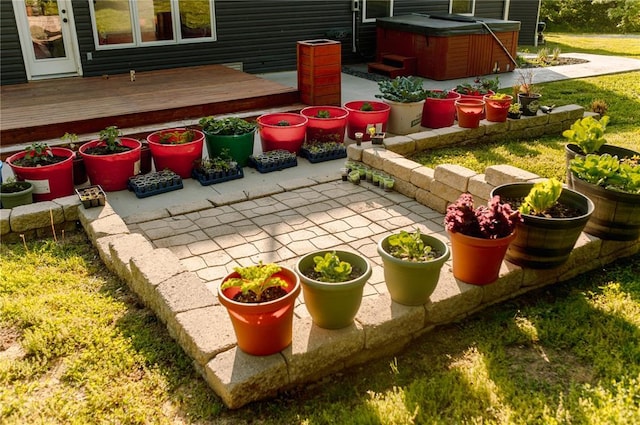 view of patio / terrace with a hot tub and a wooden deck