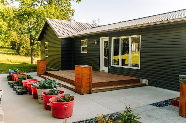 wooden deck with a patio area