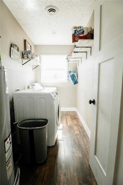 washroom with separate washer and dryer, gas water heater, dark wood-style floors, a textured ceiling, and baseboards