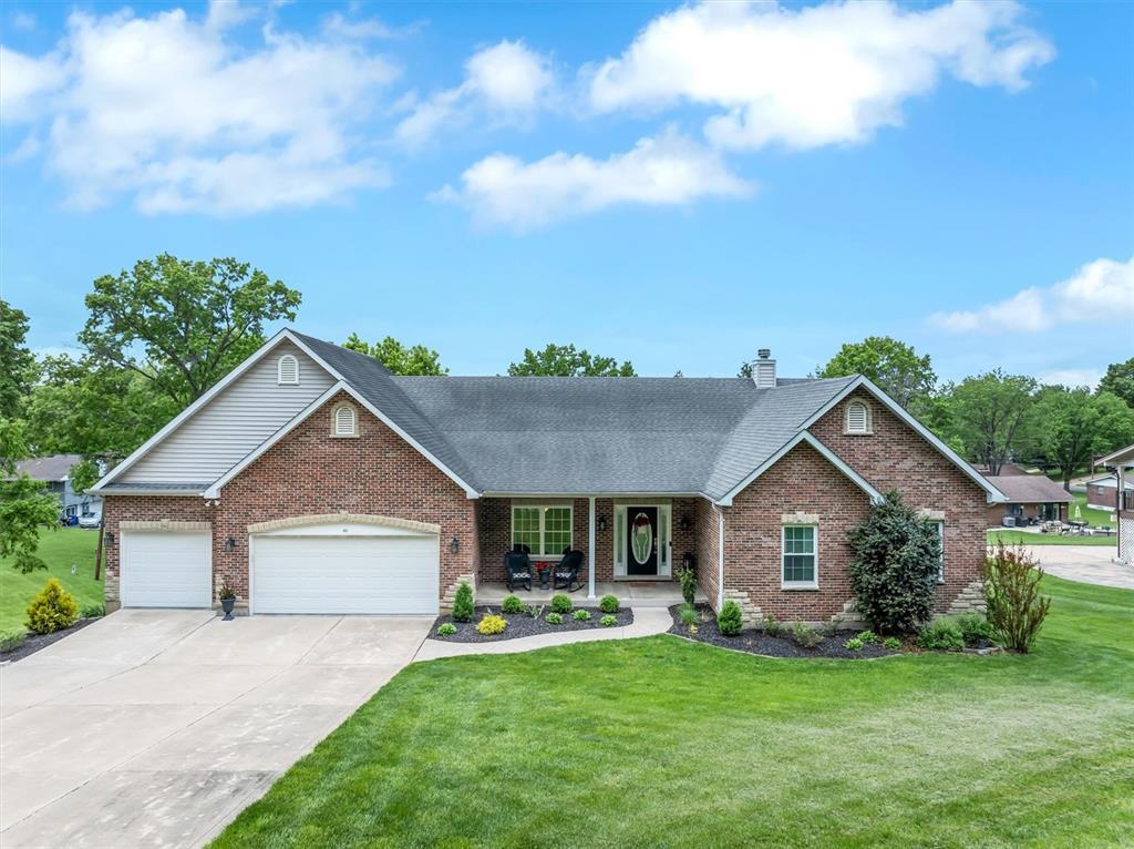 453 Augustine Rd, Saint Louis, MO 63025 - view of front of house with brick siding, a front yard, concrete driveway, and a porch