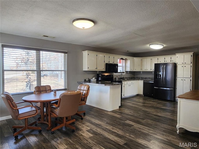 342 Deer Run Acres A, Williamsville, MO 63967 - kitchen featuring black appliances, a peninsula, a sink, dark wood-type flooring, and a textured ceiling