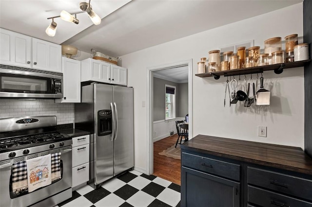 301 Dawson Ct, Webster Groves, MO 63119 - kitchen featuring stainless steel appliances, open shelves, light floors, white cabinets, and decorative backsplash