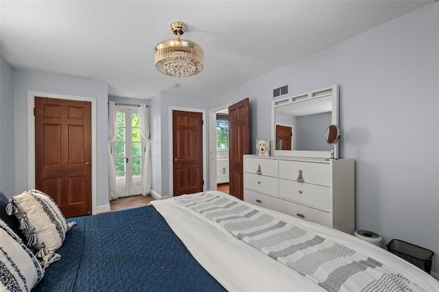 301 Dawson Ct, Webster Groves, MO 63119 - bedroom featuring baseboards and wood finished floors
