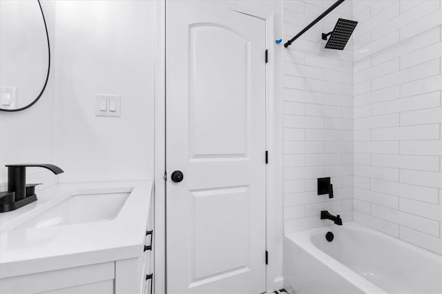 bathroom featuring washtub / shower combination and vanity