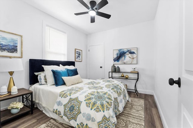 bedroom with wood finished floors, baseboards, and ceiling fan