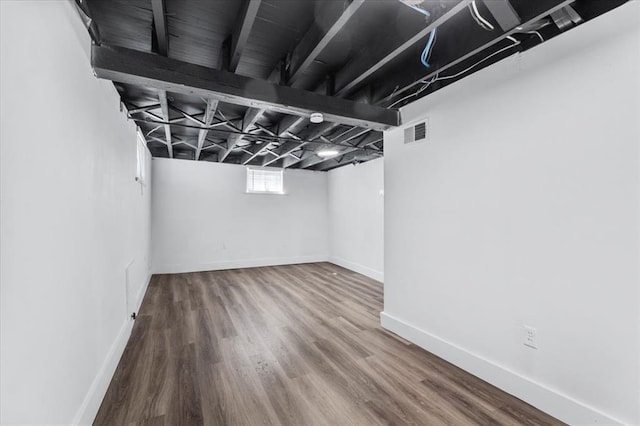 basement featuring wood finished floors and baseboards