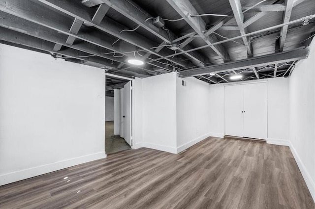 finished basement with wood finished floors and baseboards