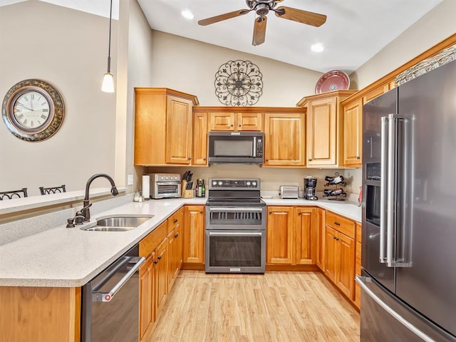 1569 Ghent Rd, Columbia, IL 62236 - kitchen featuring appliances with stainless steel finishes, a sink, a peninsula, a ceiling fan, and light wood-style flooring