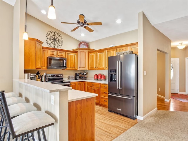 1569 Ghent Rd, Columbia, IL 62236 - kitchen with appliances with stainless steel finishes, a peninsula, light countertops, vaulted ceiling, and a ceiling fan