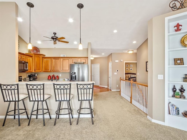 1569 Ghent Rd, Columbia, IL 62236 - kitchen with stainless steel fridge, a kitchen breakfast bar, light carpet, a peninsula, and recessed lighting