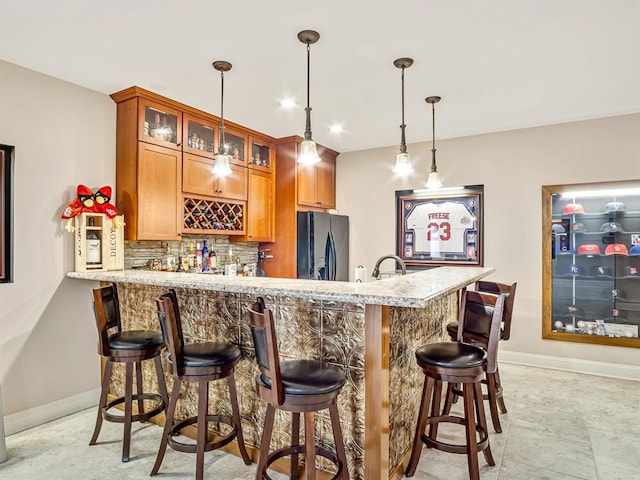 1569 Ghent Rd, Columbia, IL 62236 - indoor wet bar with black fridge with ice dispenser, decorative backsplash, baseboards, pendant lighting, and recessed lighting