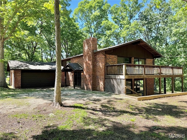 8305 Brouk Dr, Cedar Hill, MO 63016 - rear view of property with brick siding, an attached garage, a chimney, and a wooden deck