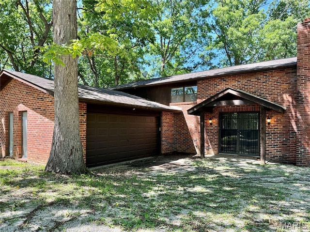 8305 Brouk Dr, Cedar Hill, MO 63016 - view of front facade featuring brick siding, an attached garage, and a chimney