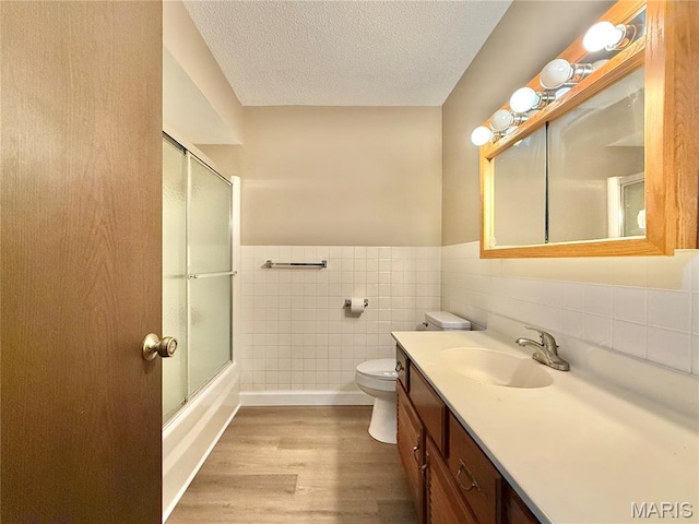 8305 Brouk Dr, Cedar Hill, MO 63016 - bathroom with tile walls, wood finished floors, vanity, toilet, and wainscoting