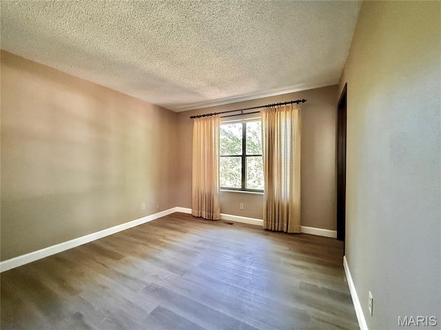 8305 Brouk Dr, Cedar Hill, MO 63016 - empty room featuring dark wood-style floors, a textured ceiling, and baseboards