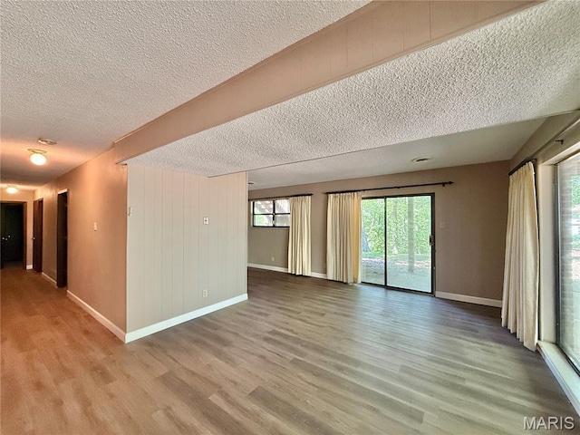 8305 Brouk Dr, Cedar Hill, MO 63016 - spare room featuring a textured ceiling, light wood finished floors, and baseboards