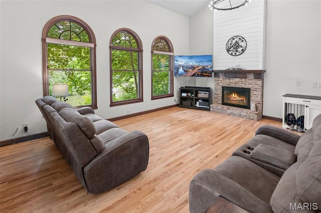 7 Tall Oaks Dr, Troy, IL 62294 - living area featuring vaulted ceiling, wood finished floors, and a fireplace