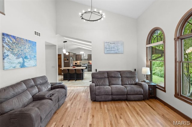 7 Tall Oaks Dr, Troy, IL 62294 - living area with high vaulted ceiling, light wood-style flooring, healthy amount of natural light, and a chandelier