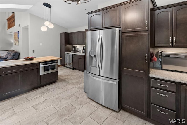 7 Tall Oaks Dr, Troy, IL 62294 - kitchen featuring stainless steel appliances, dark brown cabinets, lofted ceiling, decorative light fixtures, and wine cooler