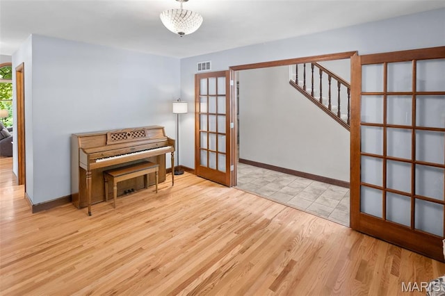 7 Tall Oaks Dr, Troy, IL 62294 - sitting room with wood finished floors, french doors, and stairs