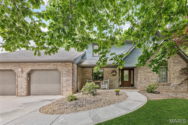 7 Tall Oaks Dr, Troy, IL 62294 - view of property with a porch, driveway, an attached garage, and brick siding