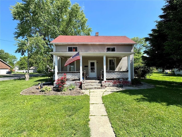 201 E 2nd N St, Mount Olive, IL 62069 - view of front of property with covered porch, a front yard, and a chimney