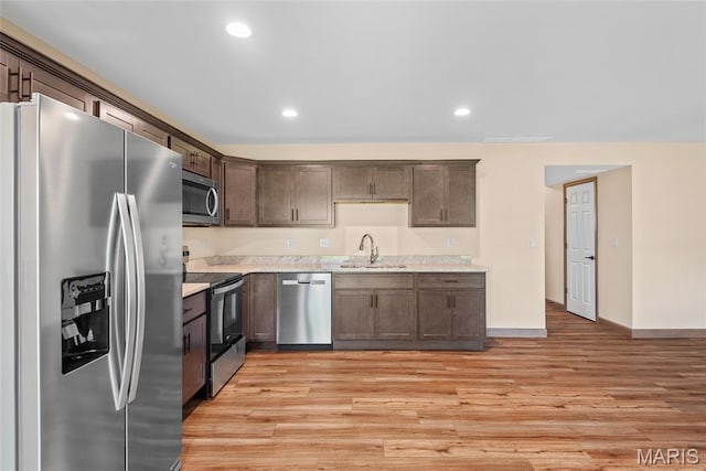 2805 Beth Ann Ct, Pontoon Beach, IL 62040 - kitchen with stainless steel appliances, dark brown cabinetry, a sink, light wood-style flooring, and baseboards