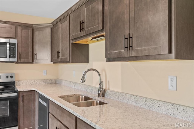 2805 Beth Ann Ct, Pontoon Beach, IL 62040 - kitchen featuring stainless steel appliances, a sink, dark brown cabinets, and light stone countertops