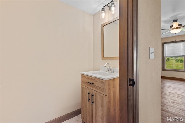 2805 Beth Ann Ct, Pontoon Beach, IL 62040 - bathroom featuring vanity, baseboards, ceiling fan, and wood finished floors