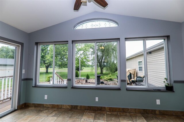 unfurnished room with vaulted ceiling, baseboards, and a ceiling fan