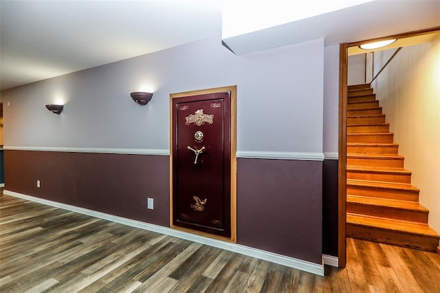 staircase with wood finished floors and baseboards