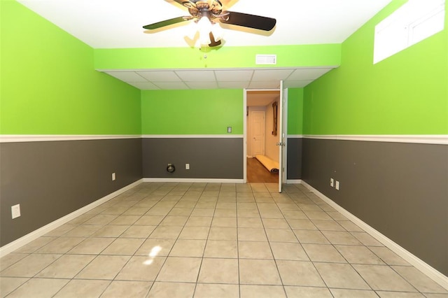tiled spare room with a ceiling fan, a paneled ceiling, and baseboards