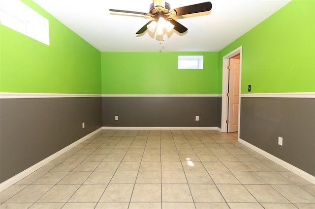 spare room featuring a ceiling fan and tile patterned flooring