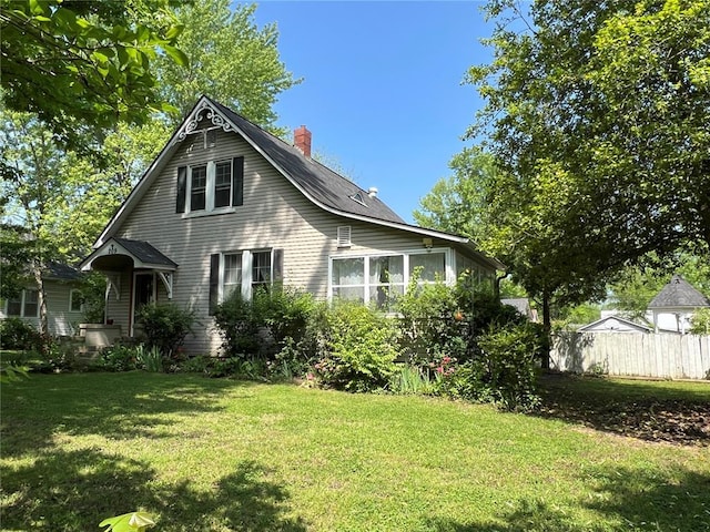 back of house with a chimney