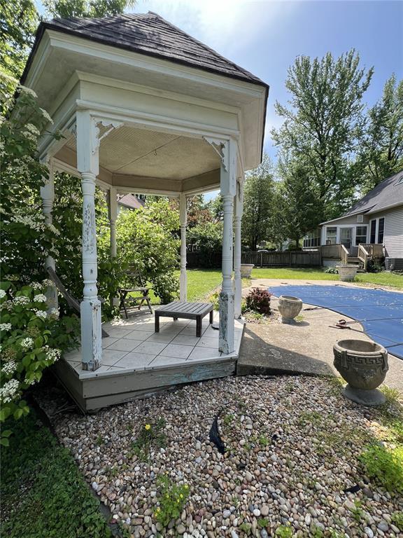 view of yard with a deck, fence, a gazebo, and a patio area